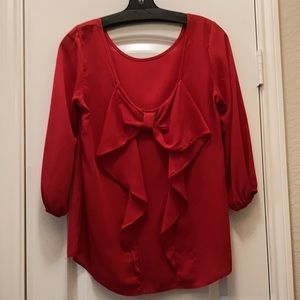 Red blouse scooped back with bow